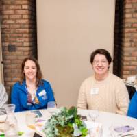 four people at luncheon table